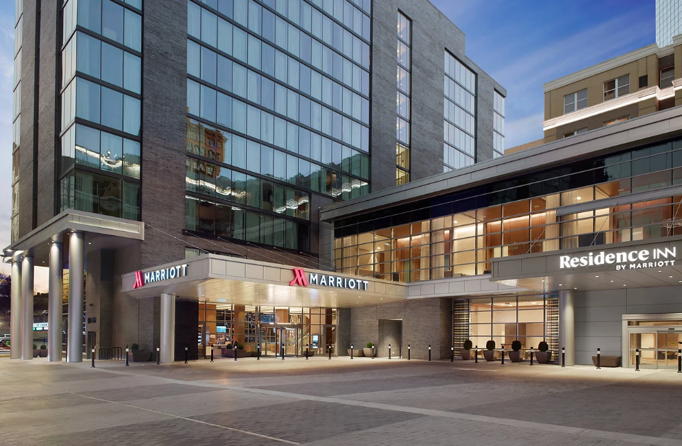 Marriott and Residence Inn hotel entrance at a mixed-use development at dusk