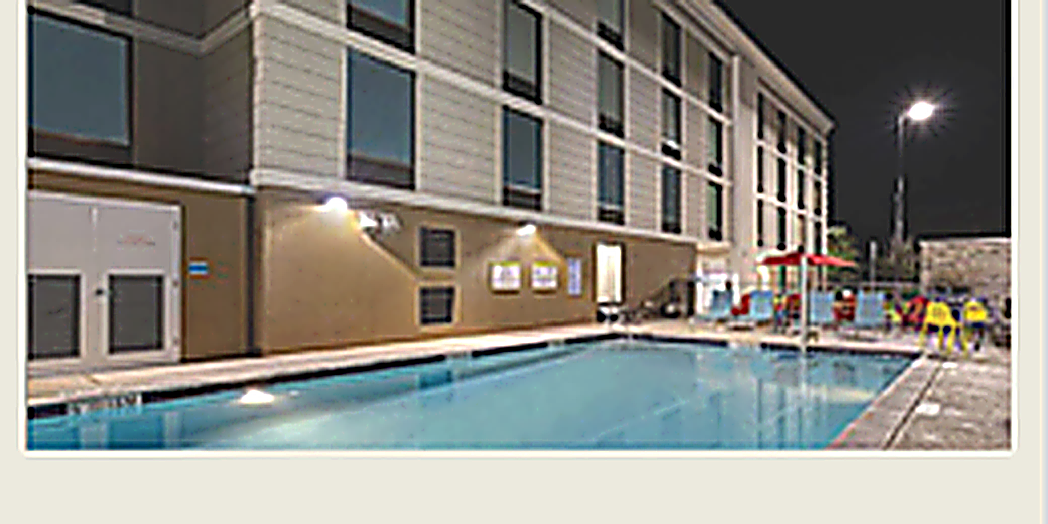 Hotel pool area lit at night
