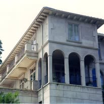 Residence exterior with arched loggia and balcony